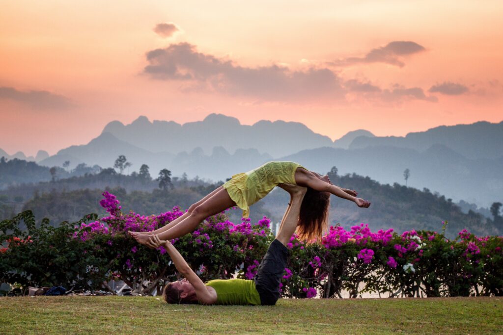 couple practicing acro yoga