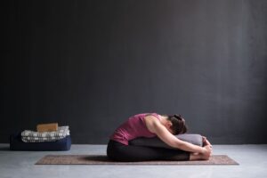 Seated Forward Bend Pose with a Blanket - Variation of Paschimottanasana